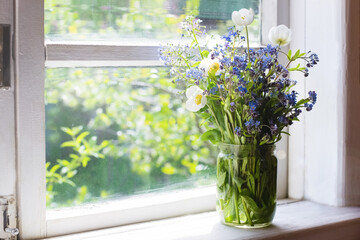 Bouquet of spring flowers on windowsill