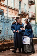 Fototapeta na wymiar A man and a woman, elegantly dressed, in 19th-century clothes, walk and talk