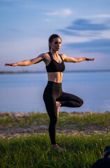 Fototapeta na wymiar sports girl doing yoga on the beach. Girl with exercise mat