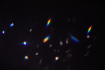 Blur colorful warm rainbow crystal light leaks on black background. Defocused abstract retro film...