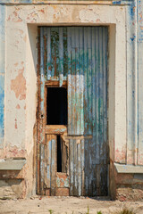 Ruins of an old school building in the city. The door of a dilapidated room. Spooky atmosphere of a place abandoned by people