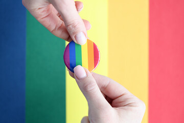 Lgbt sign in hands on background of flag