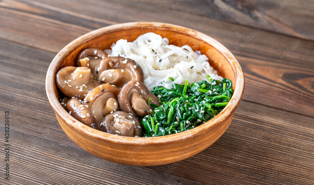 Poster bowl with rice noodles, mushrooms and spinach