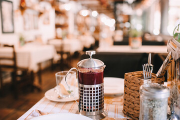coffee in cups, latte, cappuccino, sugar bowl, table set for lunch in a cafe