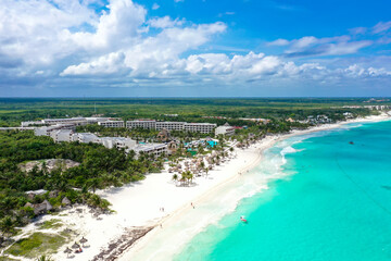 Drone photo of a white sand beach and clear blue water in Cancun, Mexico