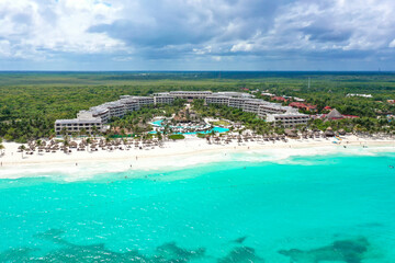 Drone photo of a white sand beach and clear blue water in Cancun, Mexico
