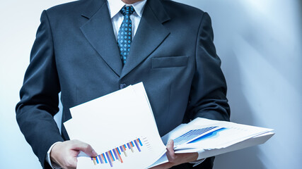 Personal financial planning concept. Businessman workplace with papers for financial planning. Business people discussing the charts and graphs showing the results of successful financial planning.