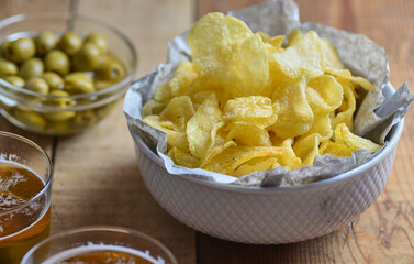 vol of potato chips in the foreground on a rustic background