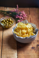 vol of potato chips in the foreground on a rustic background