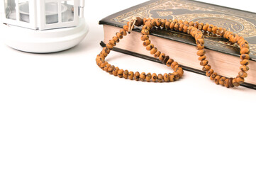 Front view of Ramadan lantern, prayer beads Malaysia, April 16, 2021-Front view of Ramadan lantern, prayer beads and holy book koran or quran isolated on a white background with copy space
