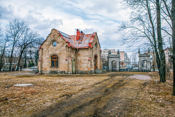 Fototapeta na wymiar Gatekeeper's house and gothic gate. Oryol Park. Strelna. St. Petersburg. Russia
