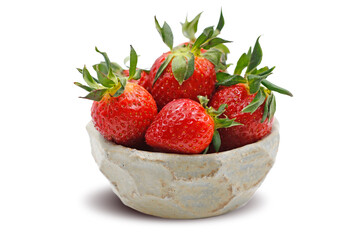 Strawberries in an authentic clay bowl. Isolated image.