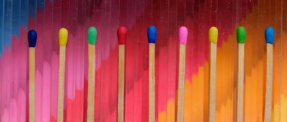 multicolored match sticks on a multicolored background