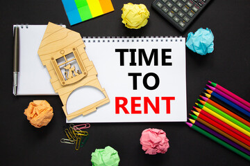 Time to rent real estate symbol. White note, words 'time to rent' on beautiful black background, metalic pen, calculator, colored pencils, miniature house. Business, time to rent real estate concept.