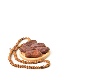 Bunch of Dates and Islamic prayer beads isolated on a white background with copy space. Ramadan kareem festive