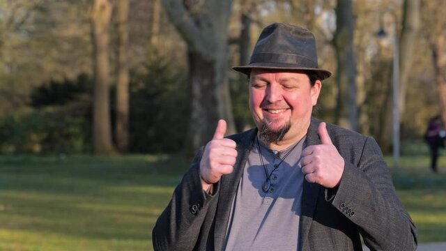 [4k] happy man in hat giving thumbs up