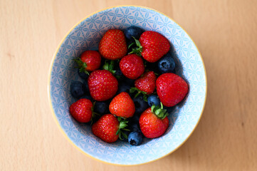 fresh Strawberry and healthy Blueberry fruits mixed in a bowl