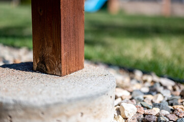 Wooden deck support free-standing on a concrete tube footing