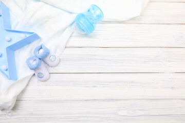 baby clothes and  attributes on a white wooden background. View from above - Image