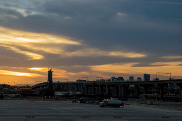 Fototapeta na wymiar Airplane at the terminal gate international airport during sunset