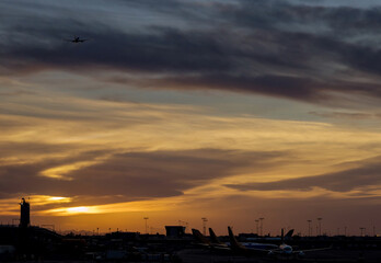 Obraz premium Airport during sunset with takeoff airplane airport boarding
