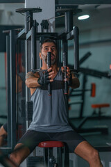 Fototapeta na wymiar Mature trainer athlete working out chest muscles doing strength training exercises on gym benchpress equipment.