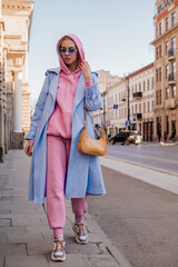 Streetstyle, street fashion concept: woman wearing trendy sport chic style outfit walking in city....