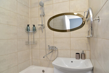 Detail of a bathroom with an oval mirror