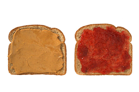 Top view of open face homemade peanut butter and jelly sandwich on wheat bread cut out on white background