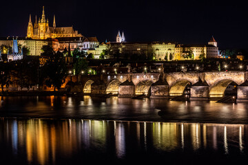 PRAGUE, CZECH REPUBLIC, 31 JULY 2020: beautiful reflection of the Castle of Prague and the Charles Bridge at night