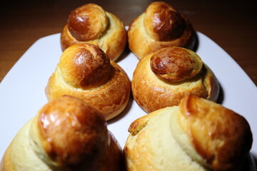 Delicious and fragrant brioches with a white plate in the background. Sicilian brioche.
