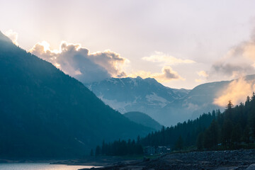 Obraz premium Sunset over the Ceresole Lake in the Italian Alps
