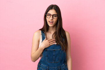 Young caucasian woman isolated on pink background pointing to oneself