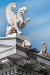 Obraz premium Zappeion Hall, Athens, Greece. The pediment of the neoclassical building Zappeion Hall. The left cape of the pediment in the form of a griffin. The gutter has the shape of a lion's head. 
