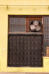 Yellow warehouse building with metal gate