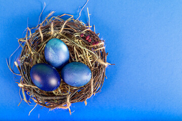 Fototapeta na wymiar Colorful background with Easter eggs on blue background. Happy Easter concept. Can be used as poster, background, holiday card. Flat lay, top view, copy space. Studio Photo
