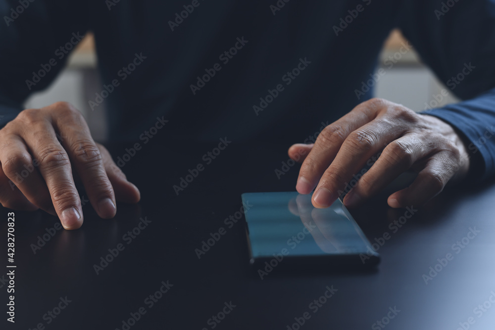 Aufkleber close up of man hand using and touching on mobile phone screen on table