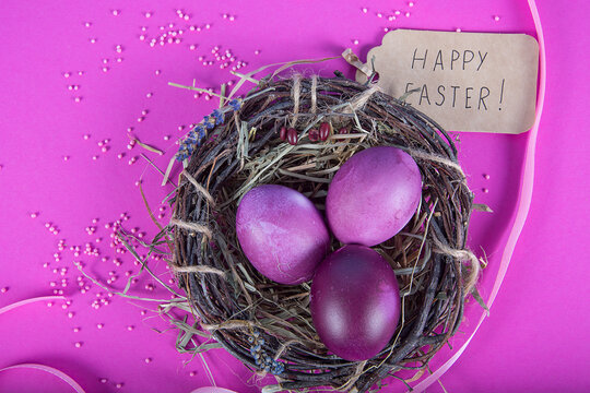 Colorful background with Easter eggs on lavender background. Happy Easter concept. Can be used as poster, background, holiday card