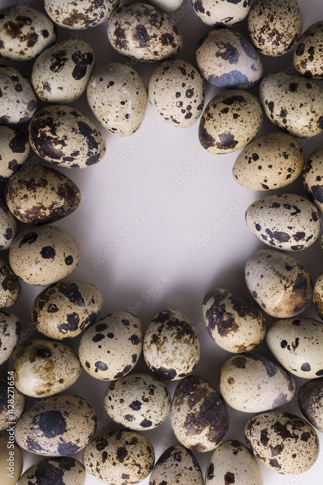 Poster vertical top view of quail eggs with space for text in the middle