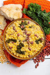 Cachupa Cape Verde traditional food with vegetables and beans macro in a bowl. Overhead view