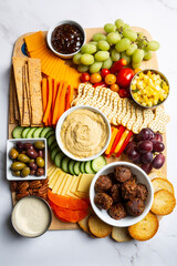 Vegan and vegetarian Charcuterie boards of assorted cheeses, meats and appetizers. Above view table scene on a marble background