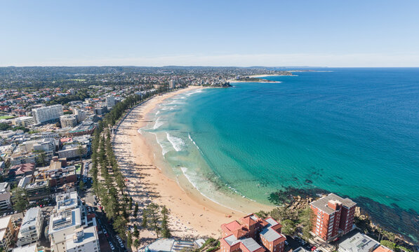 Panoramic high angle aerial drone shot of famous Manly Beach, a beach-side suburb of northern Sydney in the state of New South Wales, Australia. Northern Beaches in the background.
