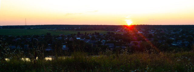 panorama overlooking the village and the dying sun at sunset.