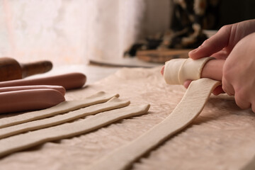 cooking sausages in dough using puff pastry.