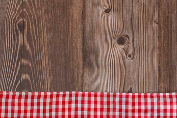 Rustic wooden background with red checkered napkin - Text space