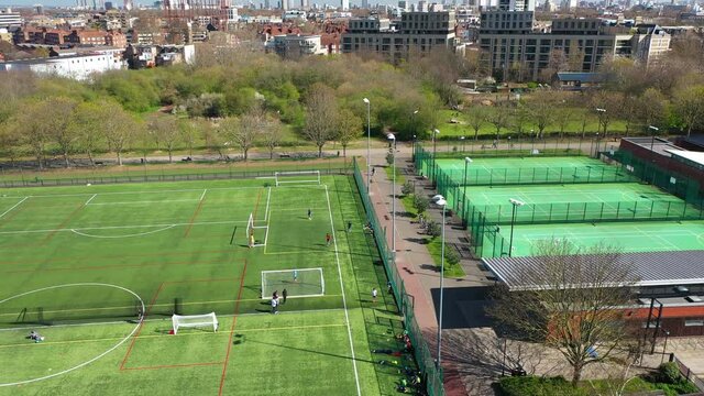 Green Artificial Soccer And Tenis Field Outdoors During Lockdown, Europe, London. Drone Shot.