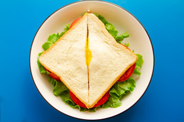 Sandwich with egg lettuce and tomato close up.