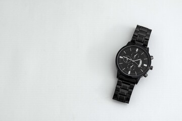 Luxury black watch on white table. Monochromatic concept. Complementary color concept. - Powered by Adobe