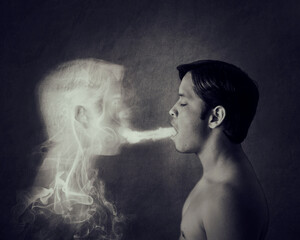 Ectoplasm and spirit concept. A man spitting out his ectoplasm or spirit.