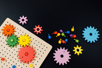 Multicolored wooden cubes on black table. Trendy puzzle toys. Geometric shapes. Back to school....